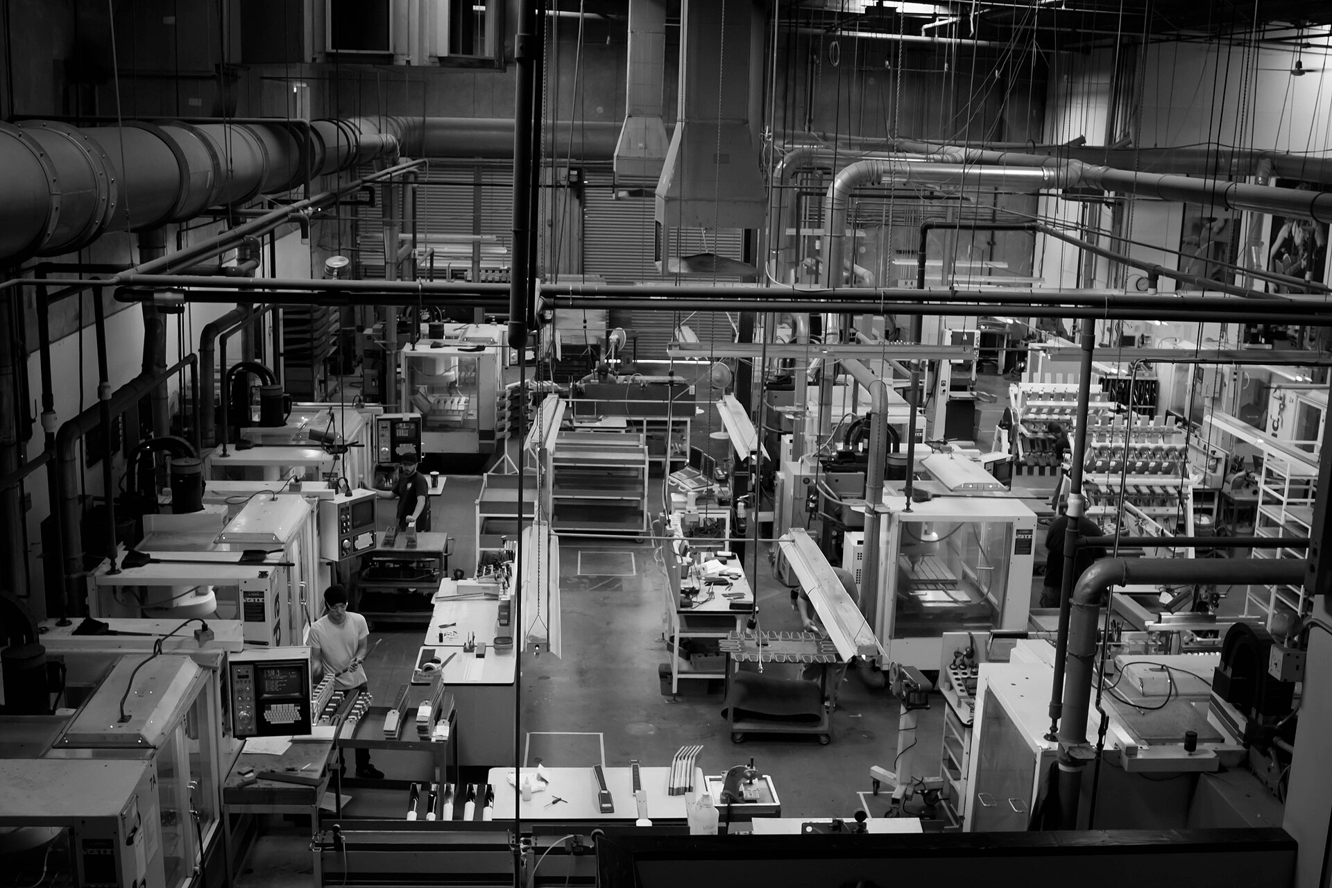 Row of CNC machining centers on a production floor (representative)